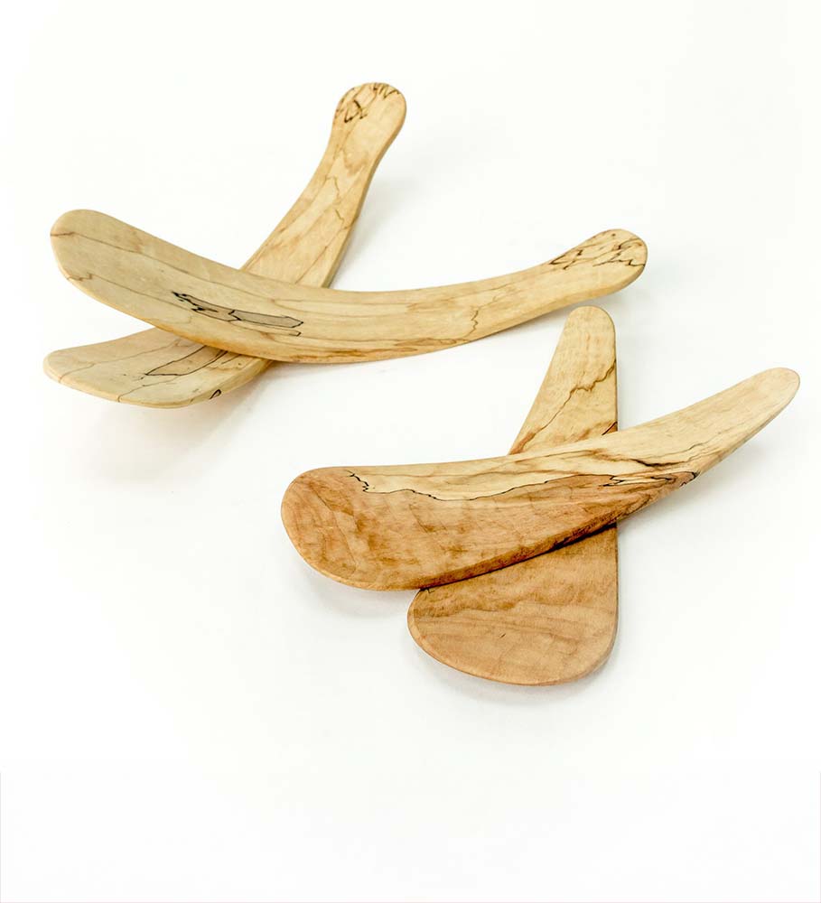 Pair of curved wooden salad tossers made from spalted maple, overlapping slightly on a bright white surface.