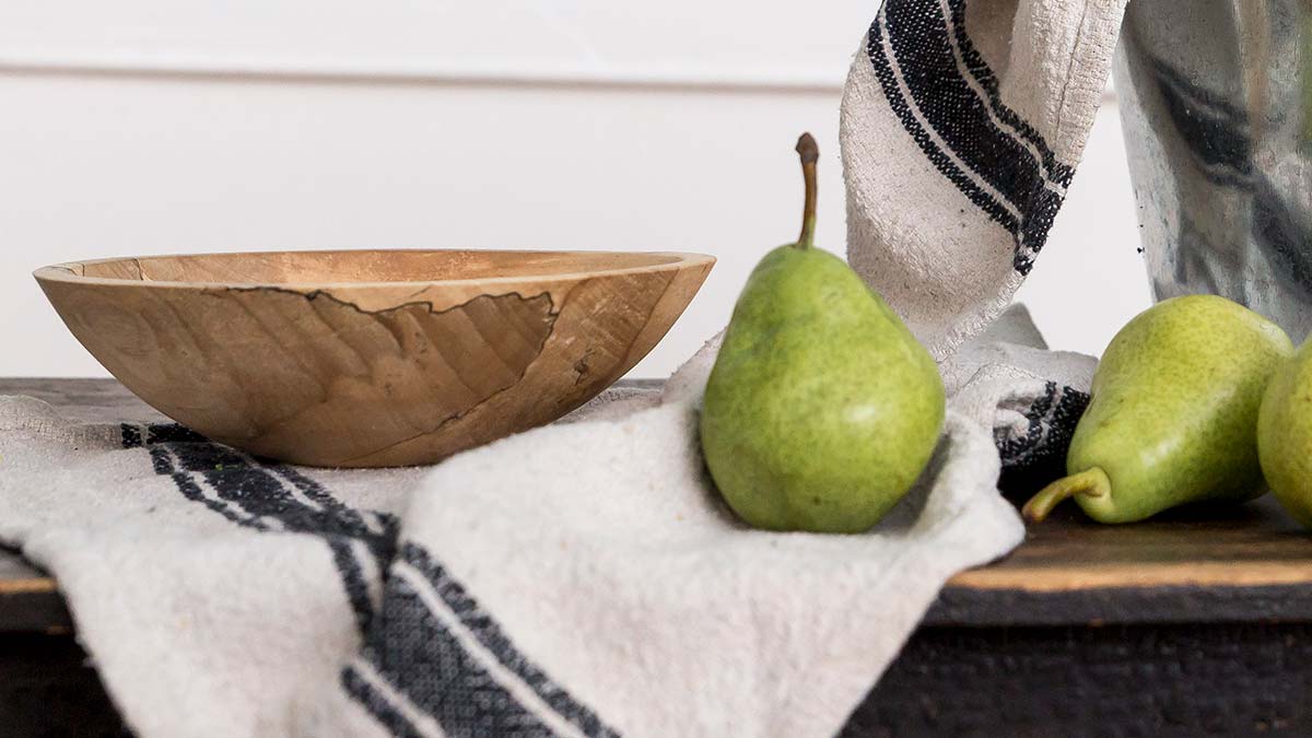 a wooden bowl on the counter as an example of one of the many Uses for a Medium Wooden Bowl
